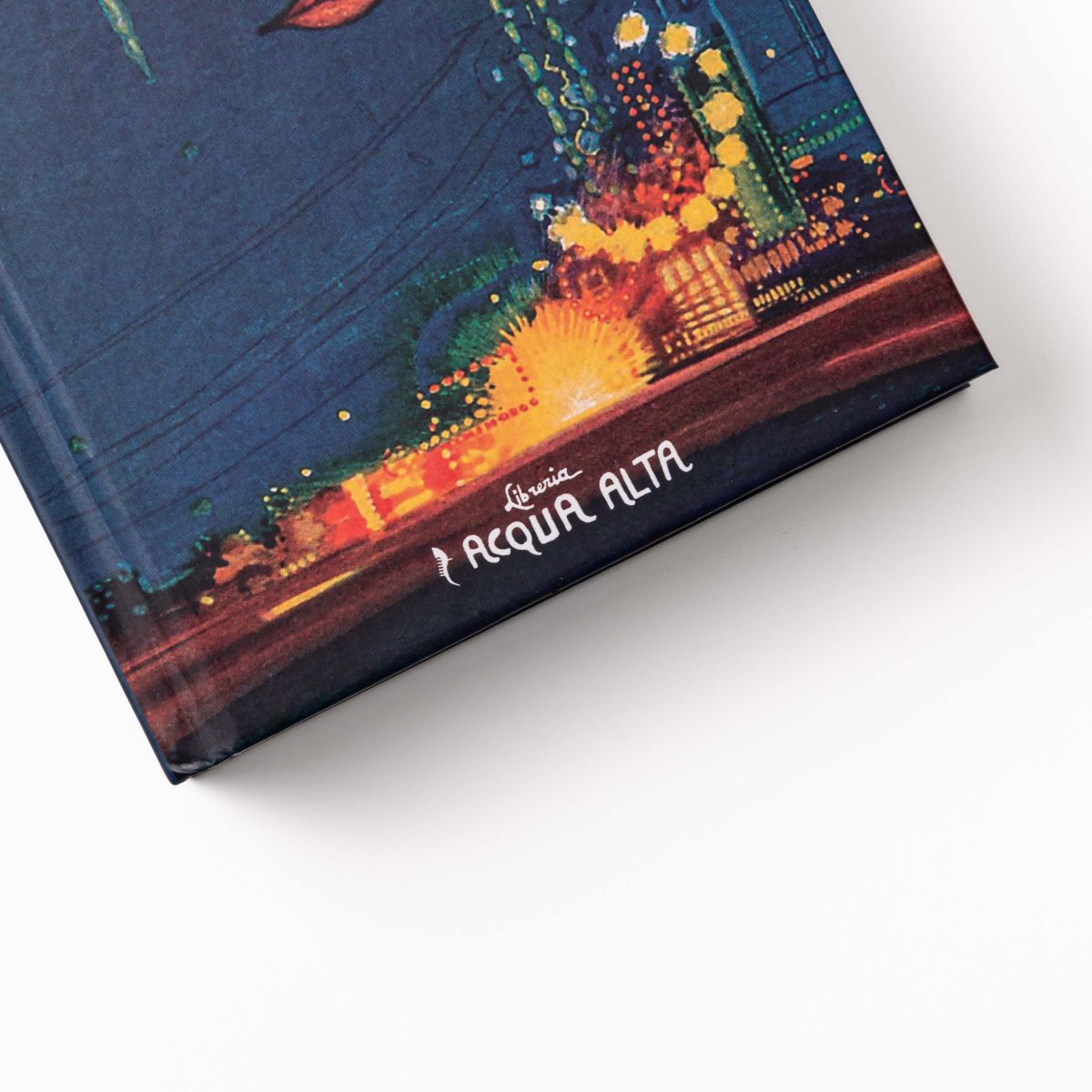 The Great Gatsby - Cover Detail Close-up of the cover of "The Great Gatsby" featuring city lights and the Libreria Acqua Alta logo